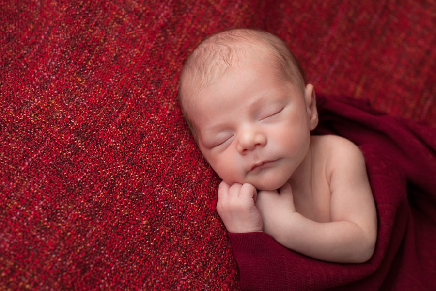 beautiful newborn baby posing in private studio session with parents